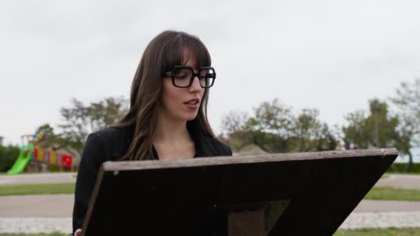 Woman Eyeglasses Reads Historical Indications Monument — Stockvideo