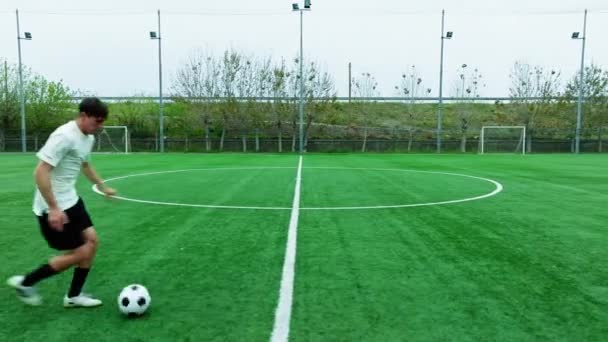Teenage Footballer Runs Alone Field — Vídeo de Stock
