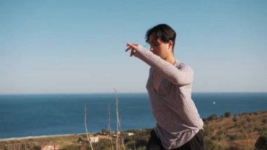 Genç çocuk kalenin yanındaki tepede Latin americano balesi yapıyor..