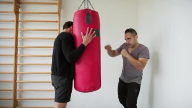 Spor salonunda spor yapan iki kişi.