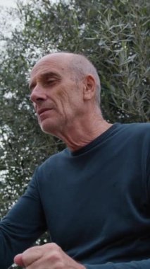 Yaşlı beyaz adam farklı bir yüz ifadesi takınıyor..