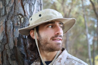 Asker yerde sürünür ve gülümseyerek bir kediye yaklaşır..