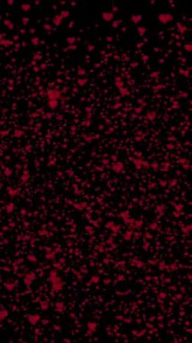 Sevgililer Günü için Kırmızı Kalpler Kalkıyor ve Siyah Arkaplanda Parıldıyor.