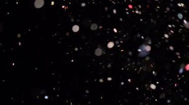 Siyah arkaplanda yüzen gerçek toz parçacıkları.