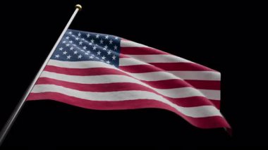 Amerika Birleşik Devletleri bayrağını siyah alfa arka planda sallıyor.