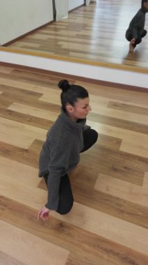 Bir balo salonunda Parke üzerinde yalınayak dans eden bir kadın.