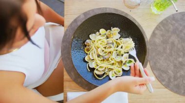 Öğle yemeğinde istiridyeli enfes bir spagetti yiyen kadın. .