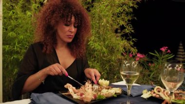 Sahildeki restoranda gurme balık yiyen bir kadın.. 