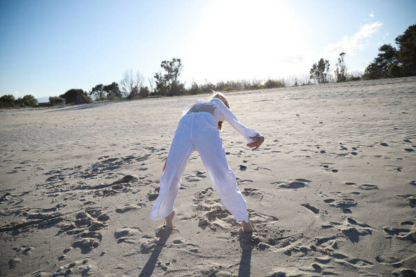 Young Italian Woman Dances On The Beach In Summer Near The Ocean .