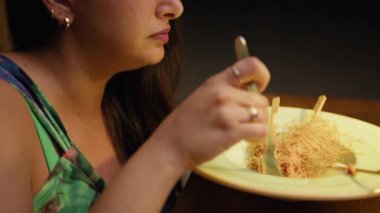 Restoranda konuşan ve yemek yiyen bir kadın. .