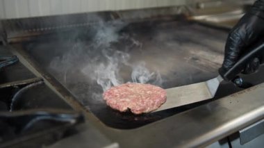 Şef ızgarada domuz eti pişiriyor Hamburger için. . 