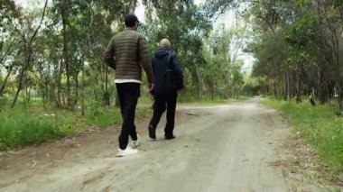 Genç Çocuk Park Yolunda Yaşlı Adamla Yürüyor.