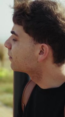 Denizin kenarındaki kaldırıma ulaşacak birini arayan yorgun bir adam. . 