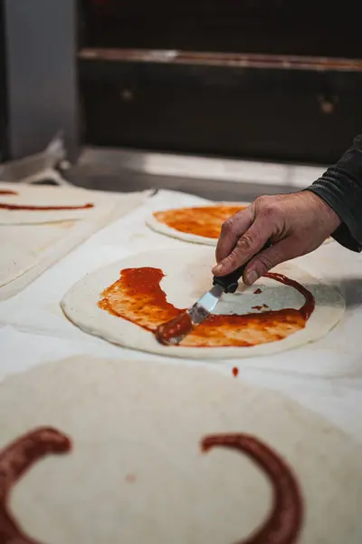 Baker Spreading Tomato Sauce Pizza Dough Bake — Stock Photo, Image