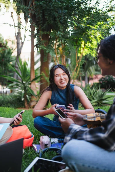 Усміхнені Студенти Коледжу Розважаються Поки Вони Сидять Траві Кампусі — стокове фото