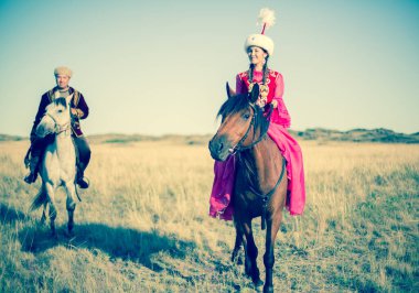 Kazakh woman and man in national costumes clipart