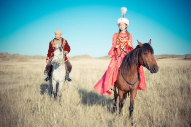 Kazakh woman and man in national costumes clipart