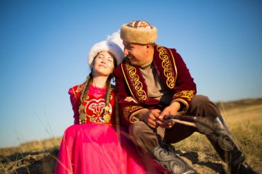 Kazakh woman and man in national costumes clipart