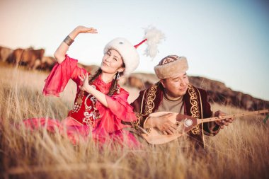 Kazakh woman and man in national costumes clipart