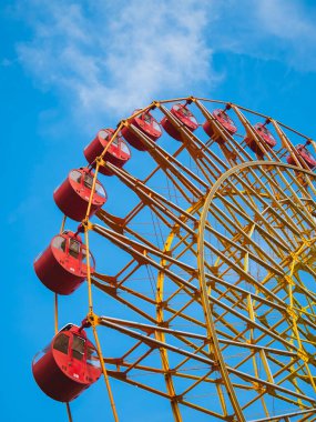 Ferris wheel close up Colorful Carnival Theme park with Day light Blue sky background