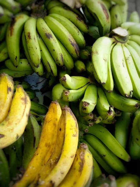 Yellowing bananas for sale at the people\'s market. Bananas contain many substances that are beneficial to the human body.