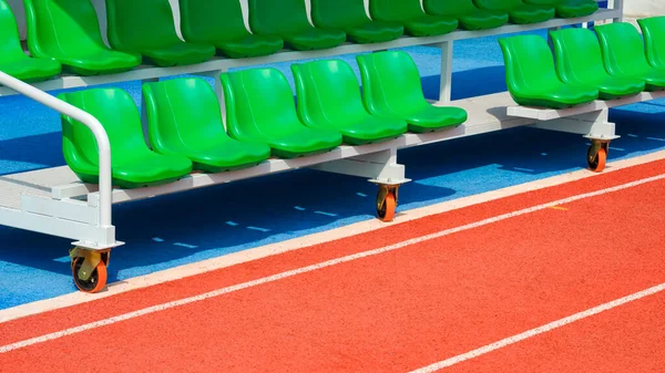 Reserve and coaching staff bench on rubber floor in outdoor sports stadium