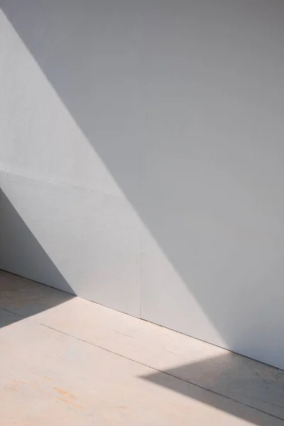stock image Background of blank gray gypsum board wall and concrete floor with light and shadow on surface in vertical frame