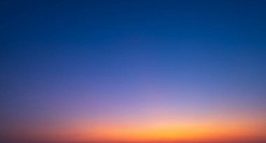 Colorful Dusk Sky in the evening, Beautiful orange sunlight on dark blue Twilight sky background