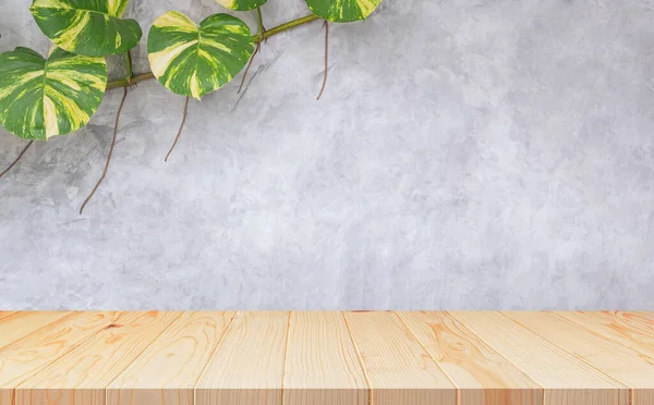 Empty wooden table with creeper plant growing on loft cement Wall Background, suitable for Product Display Presentation