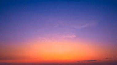Dramatic Dusk Sky background in the Evening with beautiful orange sunlight and cloud on dark blue Twilight after sundown