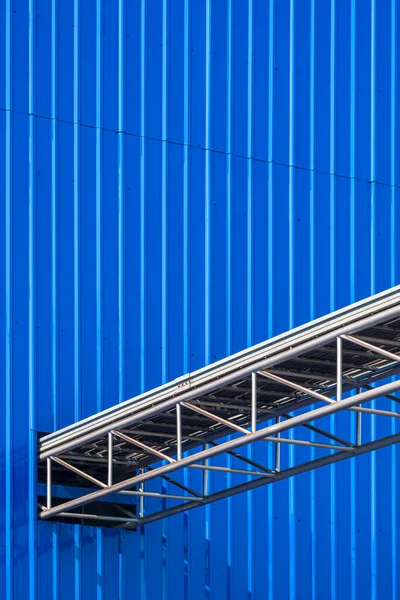 stock image Overhead Electrical Cable ladder for installing power and control cable lines from the outside into blue industrial building