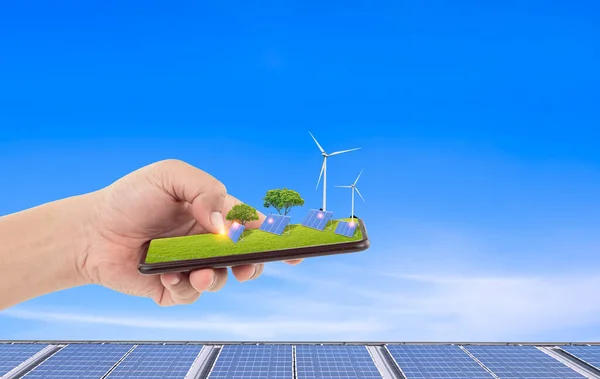 Man hand using alternative energy application on smartphone to check solar power generation system from solar panels. Modern green technology concept