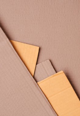 Dikey çerçevede geometrik desen arka planında istiflenmiş 5 mukavva kağıdın bir kısmı, kopyalama alanı olan üst görünüm 