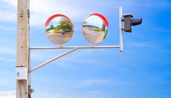 stock image 2 convex traffic mirrors with solar cell LED warning light on electric pole at the entrance and exit way of factory for increasing road safety