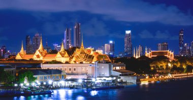 Chao Phraya nehir kenarındaki Büyük Saray ve Zümrüt Buddha Tapınağı panoramik manzaralı mavi gökyüzü arka planına karşı aydınlatma ile Bangkok şehir manzarası aydınlatma