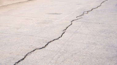 Damaged Concrete Street Background with Long Crack Line Texture on Surface