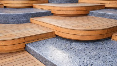 Wooden and marble seats decoration in modern curve geometric alternately and steps pattern design in viewpoint area at public park