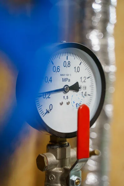 stock image Pressure manometer for measuring installed in water or gas systems. focus on the pressure manometer. Plumbing equipment.