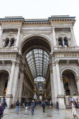 Milan, Italy - 30 December 2022: Entrance to Galleria Vittorio Emanuele II. This gallery is luxury mall and famous tourist attraction of Milan.