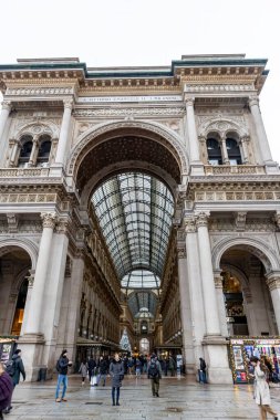 Milan, Italy - 30 December 2022: Entrance to Galleria Vittorio Emanuele II. This gallery is luxury mall and famous tourist attraction of Milan.