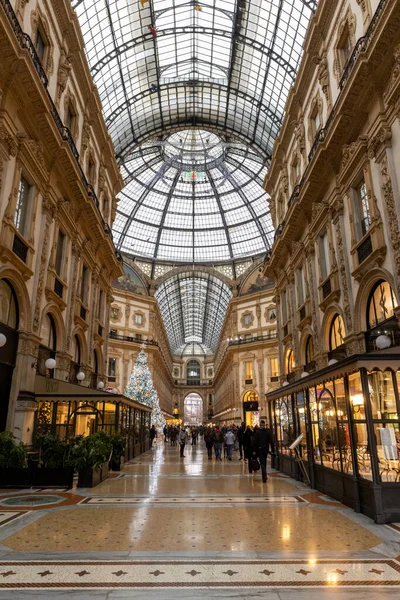 Milan, Italy - 30 December 2022: Entrance to Galleria Vittorio Emanuele II. This gallery is luxury mall and famous tourist attraction of Milan.