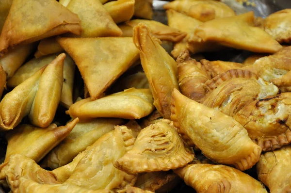 stock image Selected focus of curry puff and samosa randomly put in the containers. 