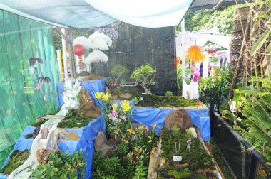 PUTRAJAYA, MALAYSIA - 6 Haziran 2015: FLORIA PUTRAJAYA bahçesinde süslemeli çiçek bahçesi ile dinlenme köşesi. Doğanın ve geri dönüşümün karışımı ya da yeniden kullanılan materyaller..