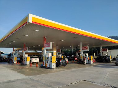 JOHOR, MALAYSIA - APRIL 8, 2022: Shell gas station in operation. Customers stop to refuel and buy goods. Several classes of petrol and diesel are sold here.