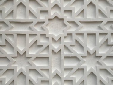 JOHOR, MALAYSIA -AUGUST 2, 2022: Islamic geometry pattern made from ground fiber reinforcement concrete used as building facade wall decoration. Permanently installed and painted.