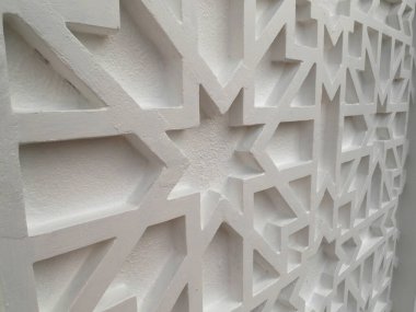 JOHOR, MALAYSIA -AUGUST 2, 2022: Islamic geometry pattern made from ground fiber reinforcement concrete used as building facade wall decoration. Permanently installed and painted.