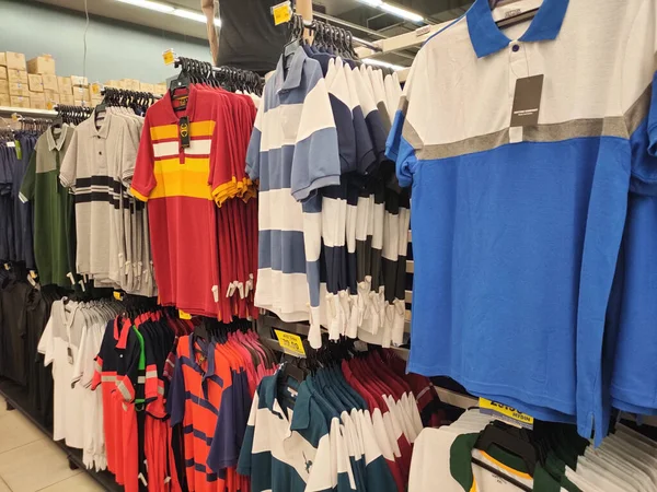 KUALA LUMPUR, MALAYSIA -JULY 8, 2022: Various types of adult men's clothes are hung and displayed for sale. Separated by type and fashion. Have a price tag for customer reference.