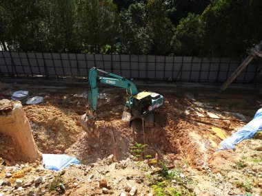 MELAKA, MALAYSIA -MARCH 1, 2022: Excavators machine at the construction site. It is used to excavate and lifting soil and other material at the construction site. 