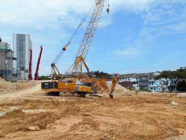 MELAKA, MALAYSIA -MARCH 1, 2022: Excavators machine at the construction site. It is used to excavate and lifting soil and other material at the construction site. 
