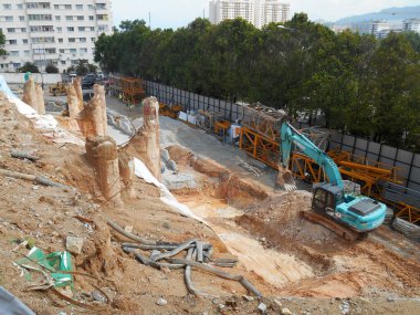 MELAKA, MALAYSIA -MARCH 1, 2022: Excavators machine at the construction site. It is used to excavate and lifting soil and other material at the construction site. 
